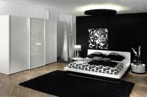 Habitacion con paredes negras y muebles blancos